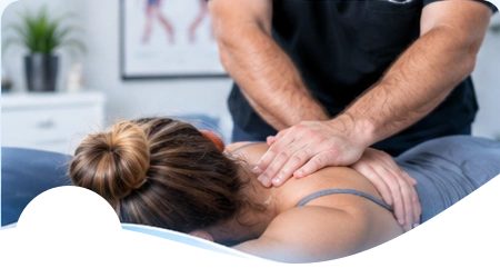 Hands applying chiropractic care to a patient’s upper back.